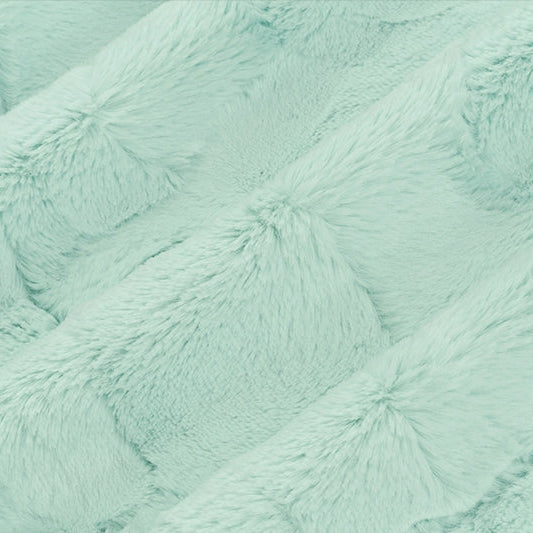 Close-up of a textured turquoise fabric surface