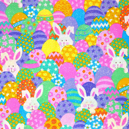 Colorful fabric pattern with Easter eggs and bunnies, featuring a ruler at the bottom for scale.