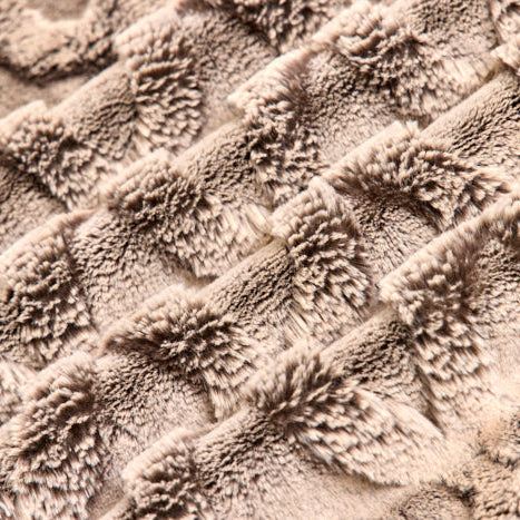 Close-up of textured beige fabric with a wavy pattern