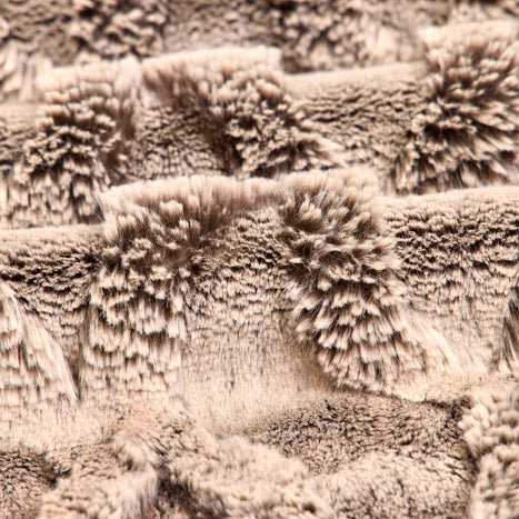 Close-up of textured beige fabric with a soft, plush surface.