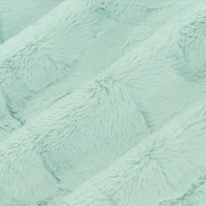 Close-up of a textured turquoise fabric surface